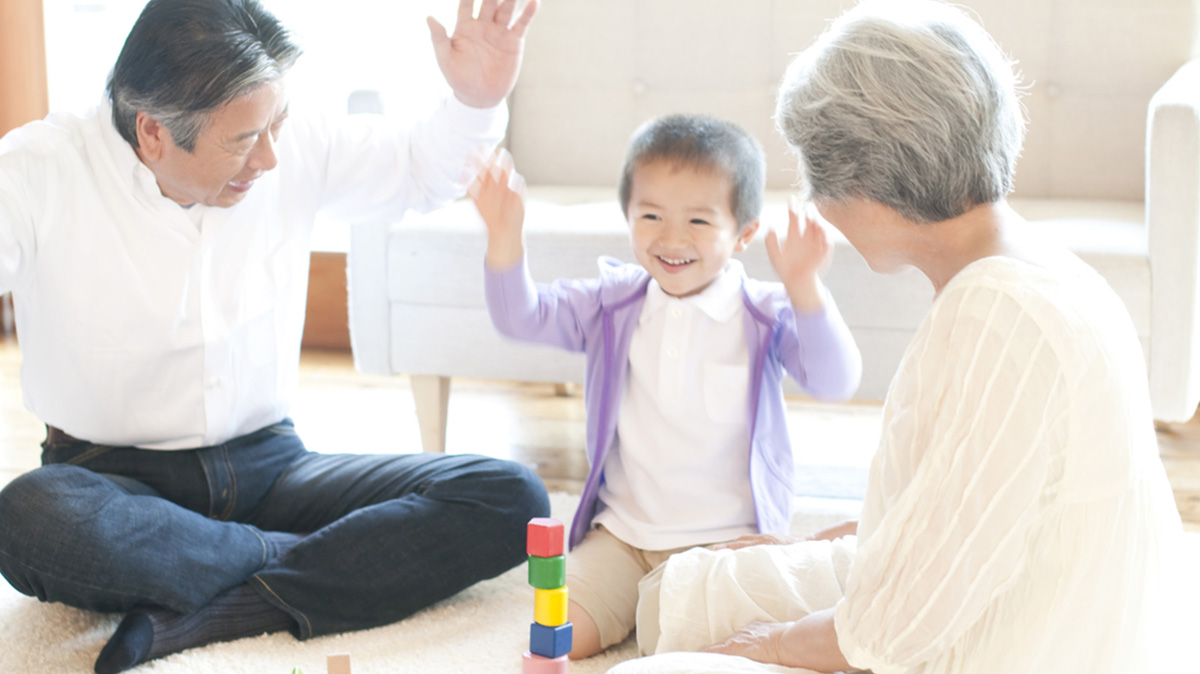 Grandparents Enjoy Playing With Their Grandson At Mulberry Grove Luxury Private Villas